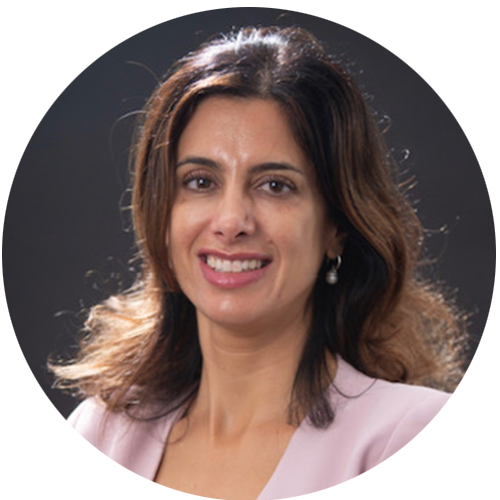 Christine is smiling for a professional headshot in front of a dark grey background.